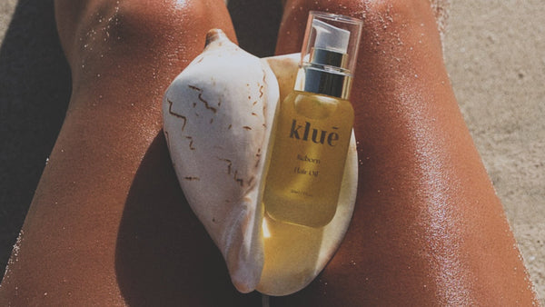 Klue bottle of oil on a textured surface